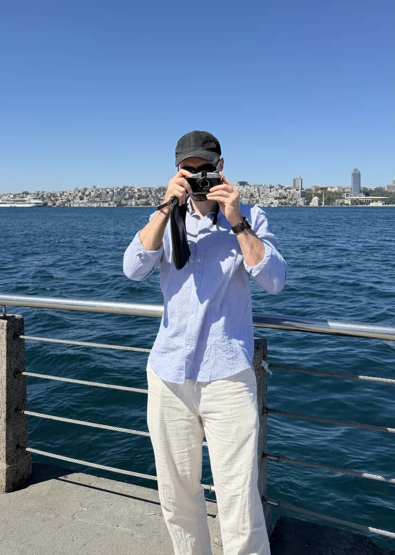 Gus taking a photo with a film camera